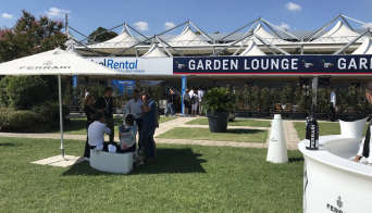 View of the outdoor seating area with guests enjoying a drink in the shade at the Garden Lounge