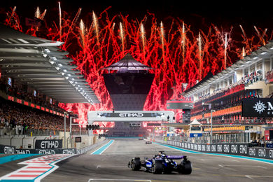 Fireworks going off as the F1 cars come down the Main Straight for the last time