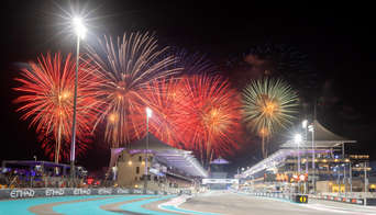 The Main Straight of Yas Marina Circuit with fireworks going off in the background