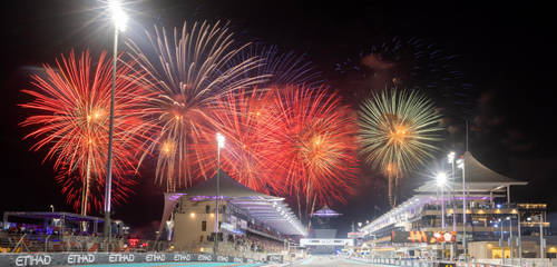 The Main Straight of Yas Marina Circuit with fireworks going off in the background