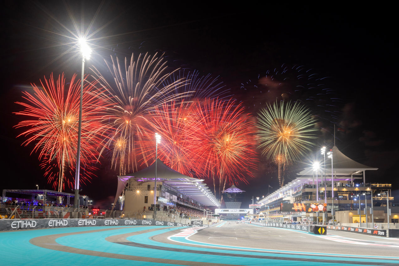 The Main Straight of Yas Marina Circuit with fireworks going off in the background
