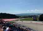Fans watch the F1 cars take on the last corner of Red Bull Ring from Grandstand T9