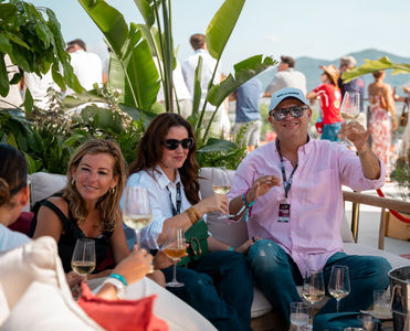 Pit Lane Lounge guests enjoying a drink on the covered terrace