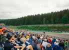 Alpine F1 car driving past the Speed Corner Grandstand during the Belgian GP