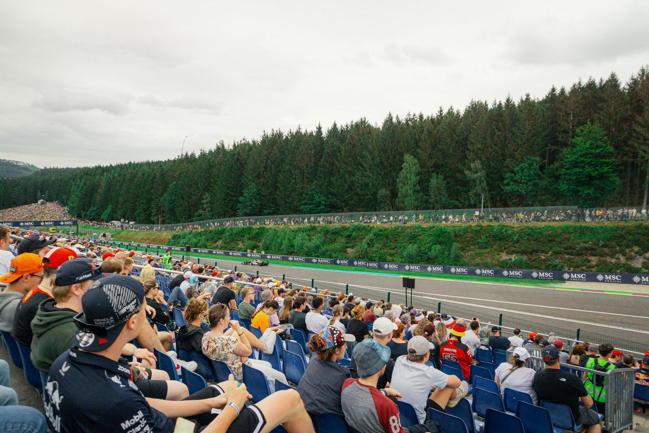 Alpine F1 car driving past the Speed Corner Grandstand during the Belgian GP