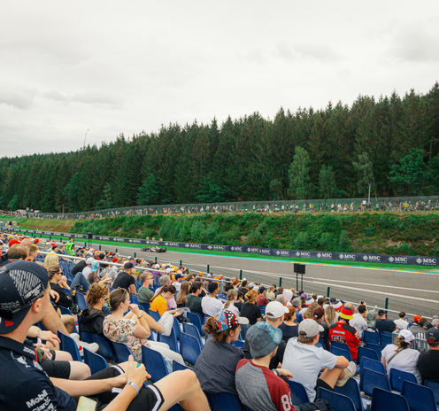 Alpine F1 car driving past the Speed Corner Grandstand during the Belgian GP