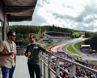 Guests enjoying a glass of Champagne on the balcony of the Gold 2 VIP Lounge