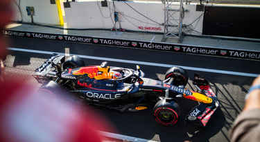 Max Verstappen in his Red Bull F1 car, photographed from the balcony of the Race Club