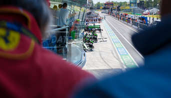 The F1 cars getting ready to enter the track, seen from the Race Club balcony