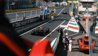 See the F1 cars up close from the Race Club as they exit the pit lane