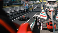 See the F1 cars up close from the Race Club as they exit the pit lane
