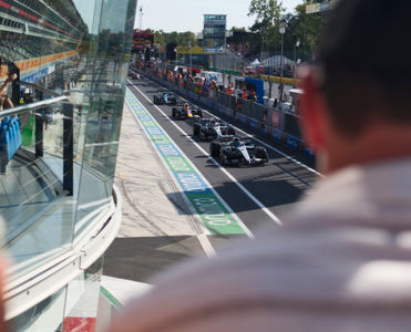 F1 cars lining up in the pit lane on Monza Circuit