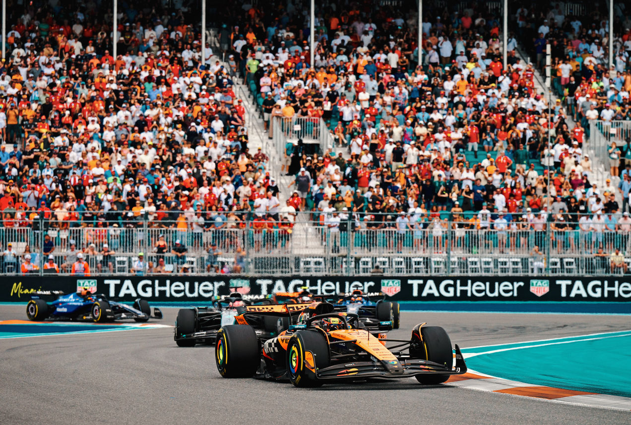 F1 cars on Miami International Autodrome with one of the grandstands in the background