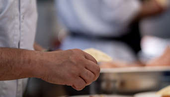 A chef plating up some food in the Start/Finish VIP Terrace