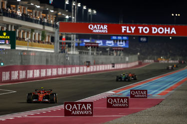 The Main Straight of Losail International Circuit with a Ferrari car among others on it