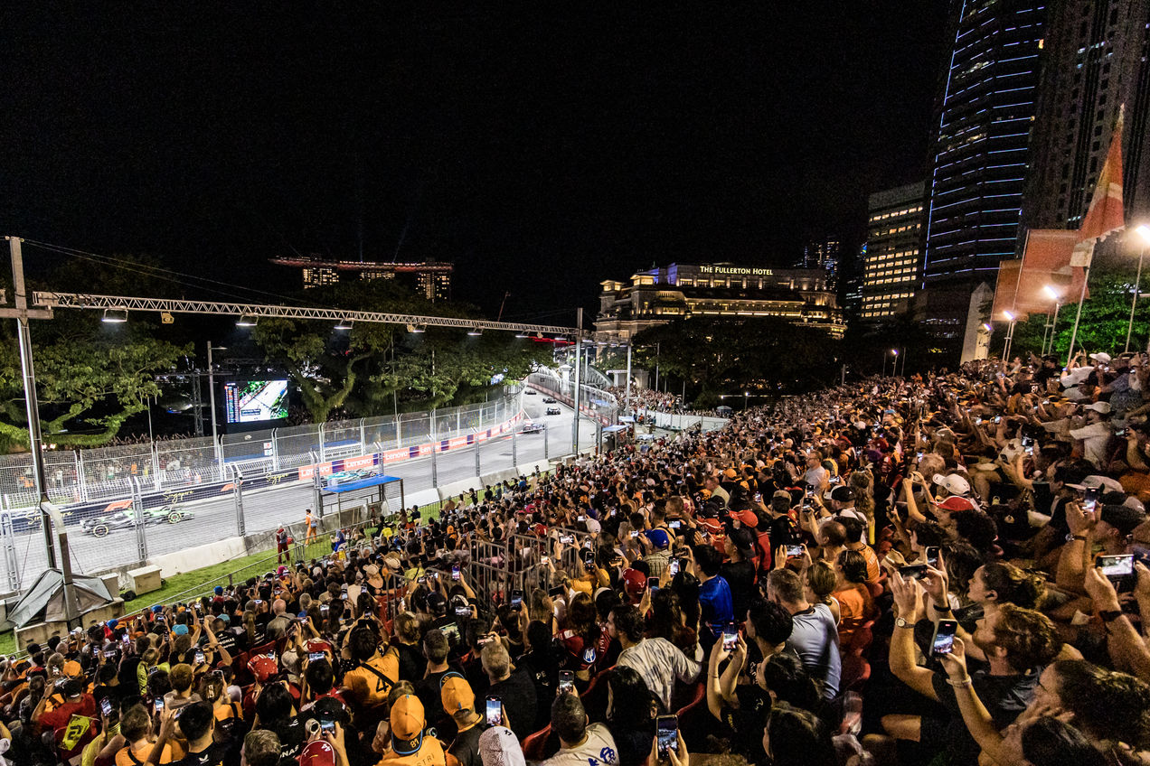 Fans on the Empress Grandstand watching the F1 cars drive by at the Singapore GP