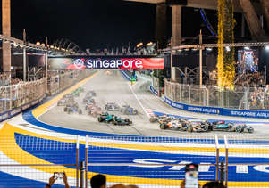 The F1 cars racing through the first corner of Marina Bay Circuit
