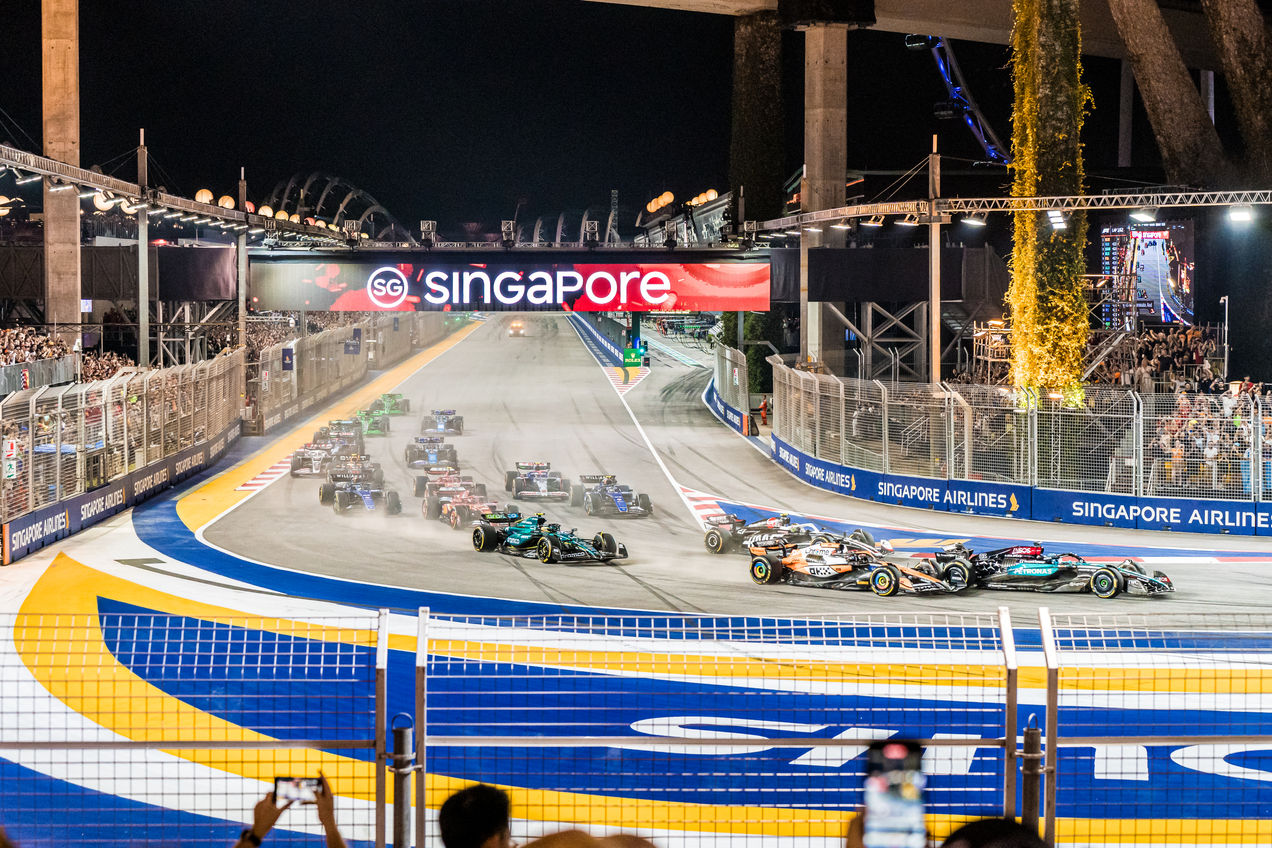 The F1 cars racing through the first corner of Marina Bay Circuit