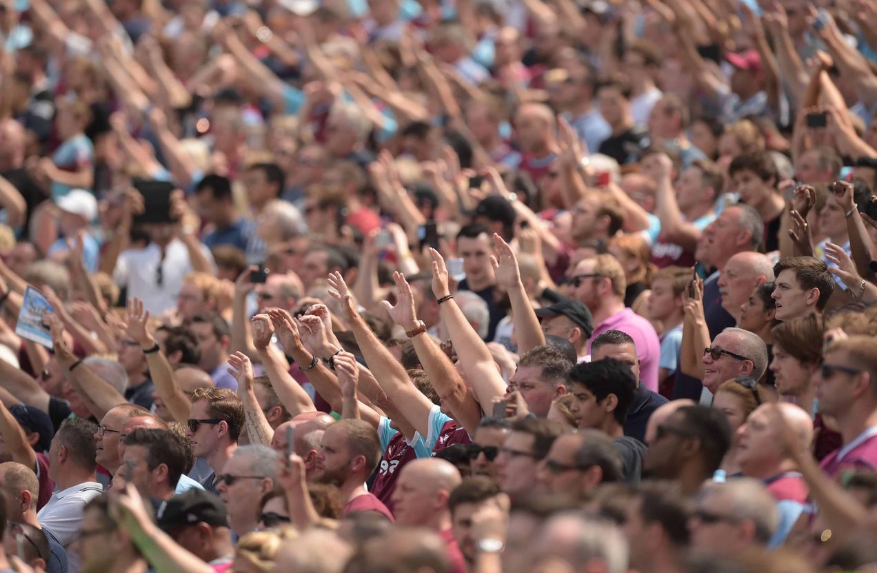 Young disappointed football fan sitting in empty stadium