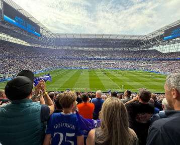 Everton fans watching a match from the stands at Goodison Park