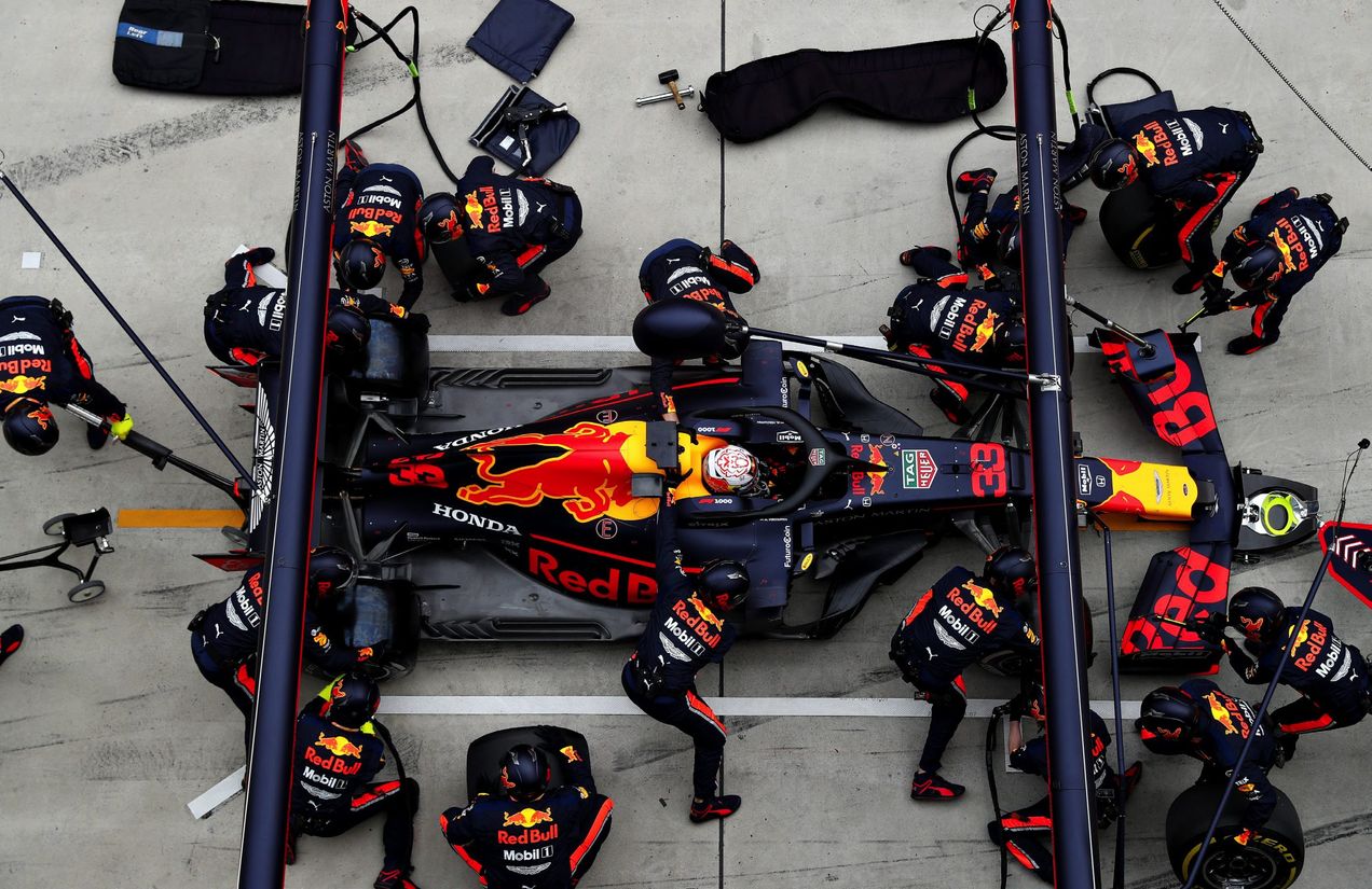 A Red Bull F1 car in the middle of a pit stop