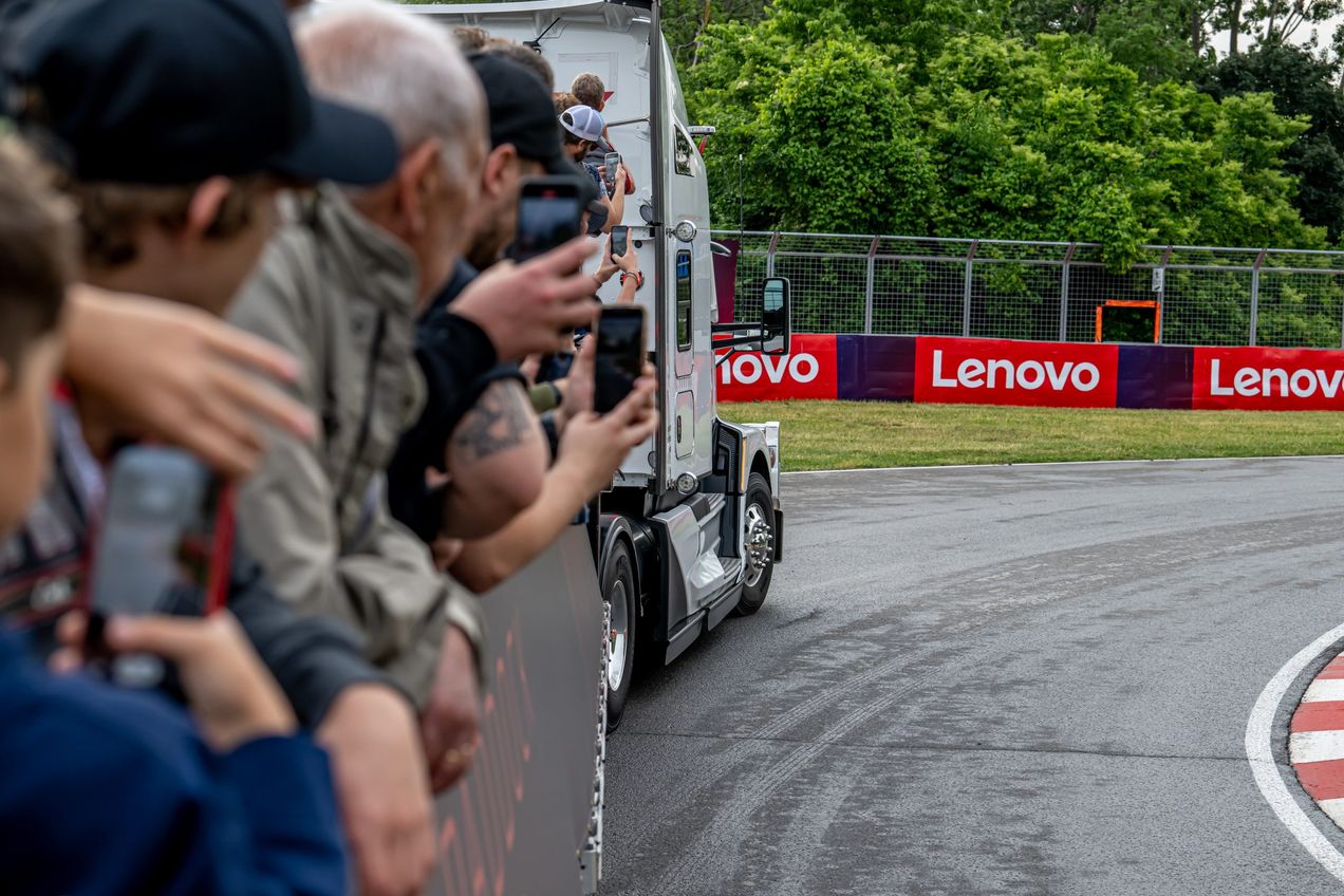 Formula One fans ride in a flatbed truck around the circuit at the Canadian Grand Prix