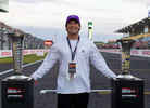 An F1 fan poses for a photo with the championship trophies