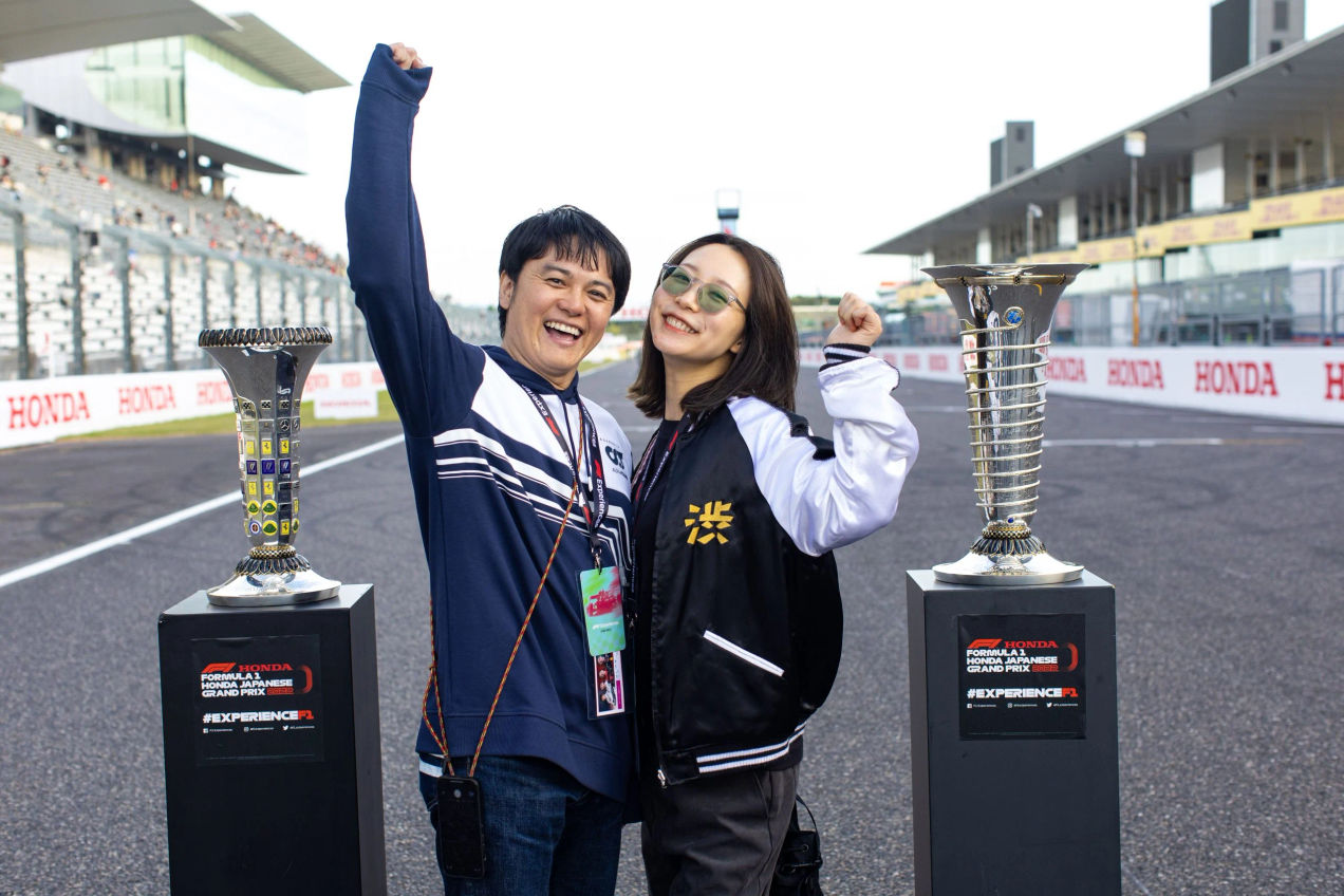 Fans pose with the Championship trophies at the Japanese GP