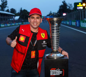 A Ferrari fan takes a photo with the Championship Trophy, part of the F1 Experiences weekend