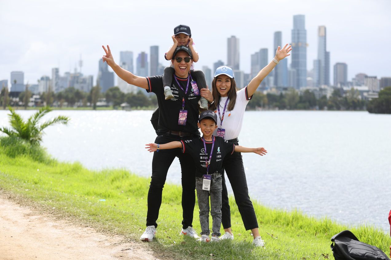 A family dressed in F1 merchandise posing for a photo at Albert Park