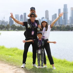 A family dressed in F1 merchandise posing for a photo at Albert Park