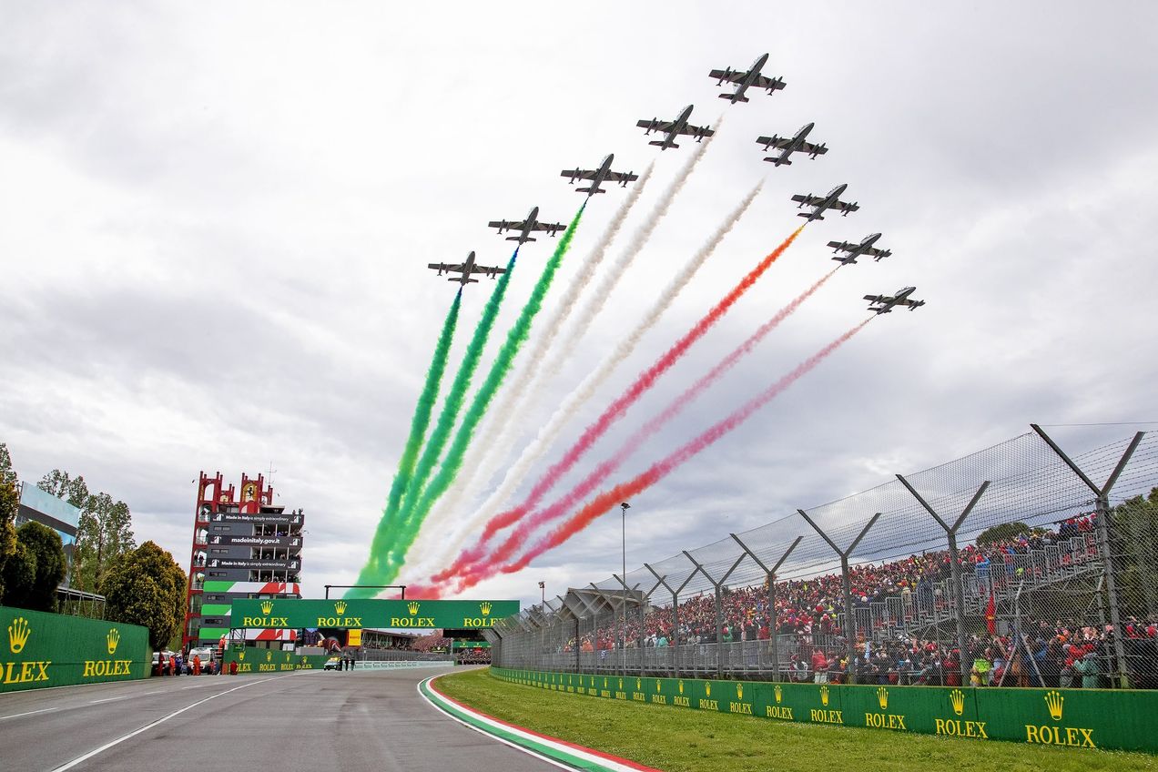 Planes with green, white and red smoke trails fly over the Autodromo Enzo e Dino Ferrari circuit at the Imola GP
