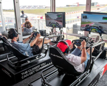 Guests of the Champions Club drive race simulators in the lounge
