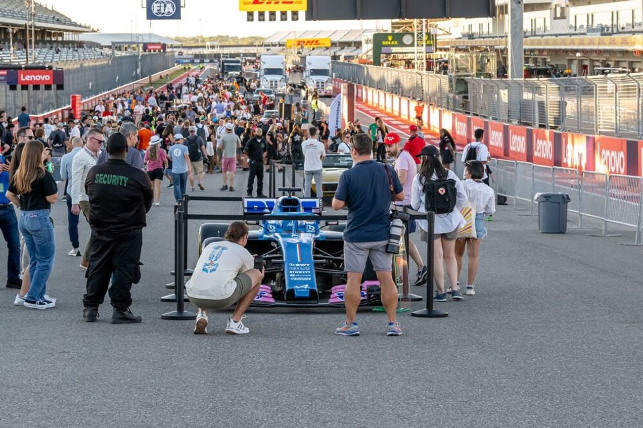 F1 fans examine an Aston Martin car up close during the F1 Live events
