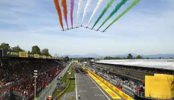 Planes fly overhead releasing red, white and green smoke at the Monza GP