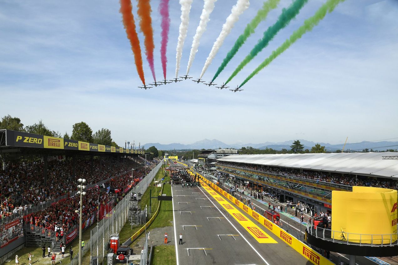 Planes fly overhead releasing red, white and green smoke at the Monza GP