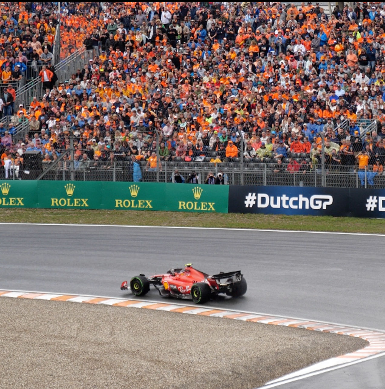 A Ferrari F1 car races around Zandvoort circuit at the Dutch GP