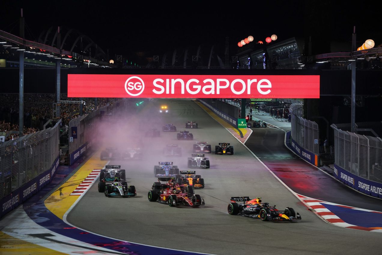 Formula One race cars taking the first corner at Turn 1 during the Singapore GP