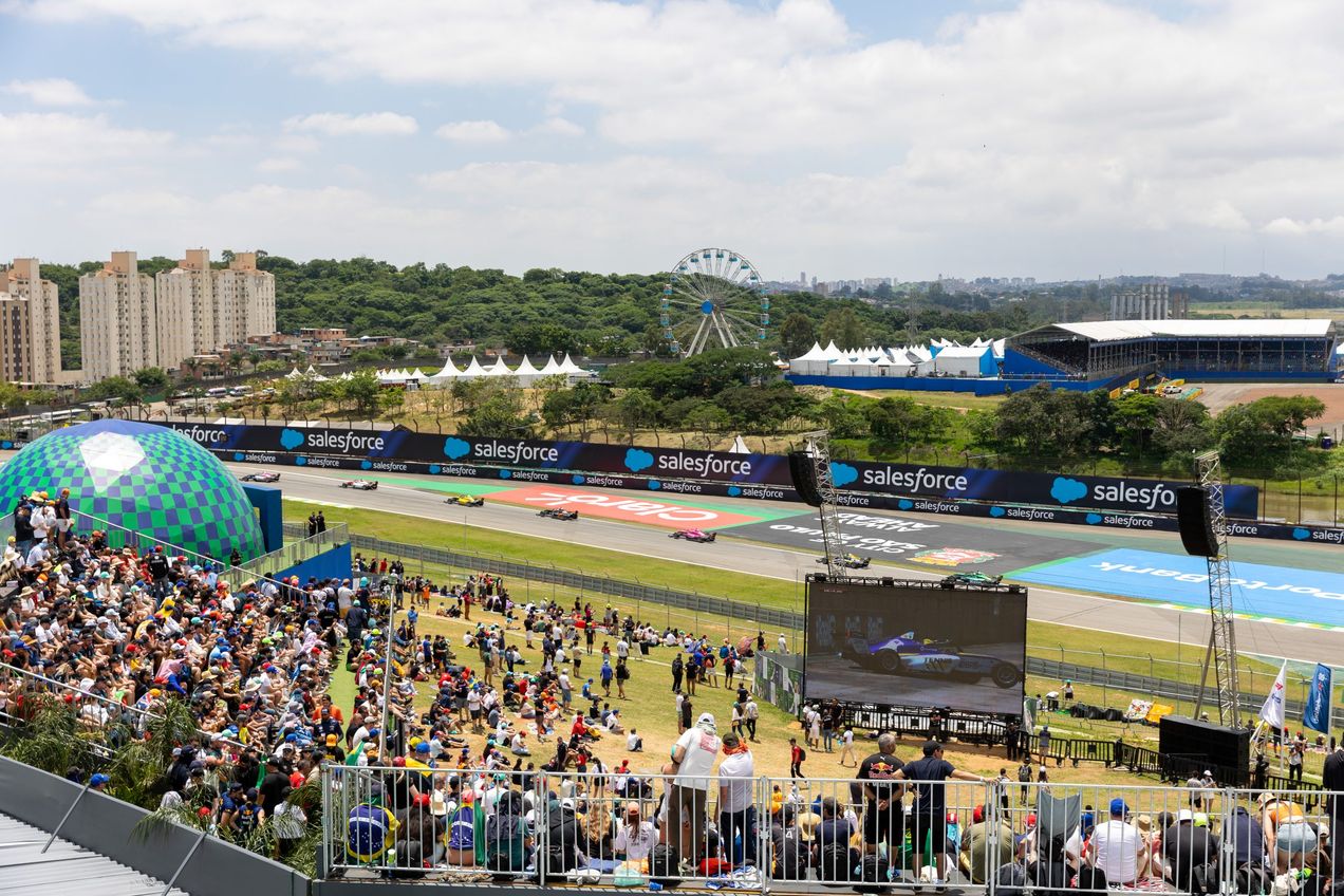 View of the Heineken Village field with giant screen and race track behind