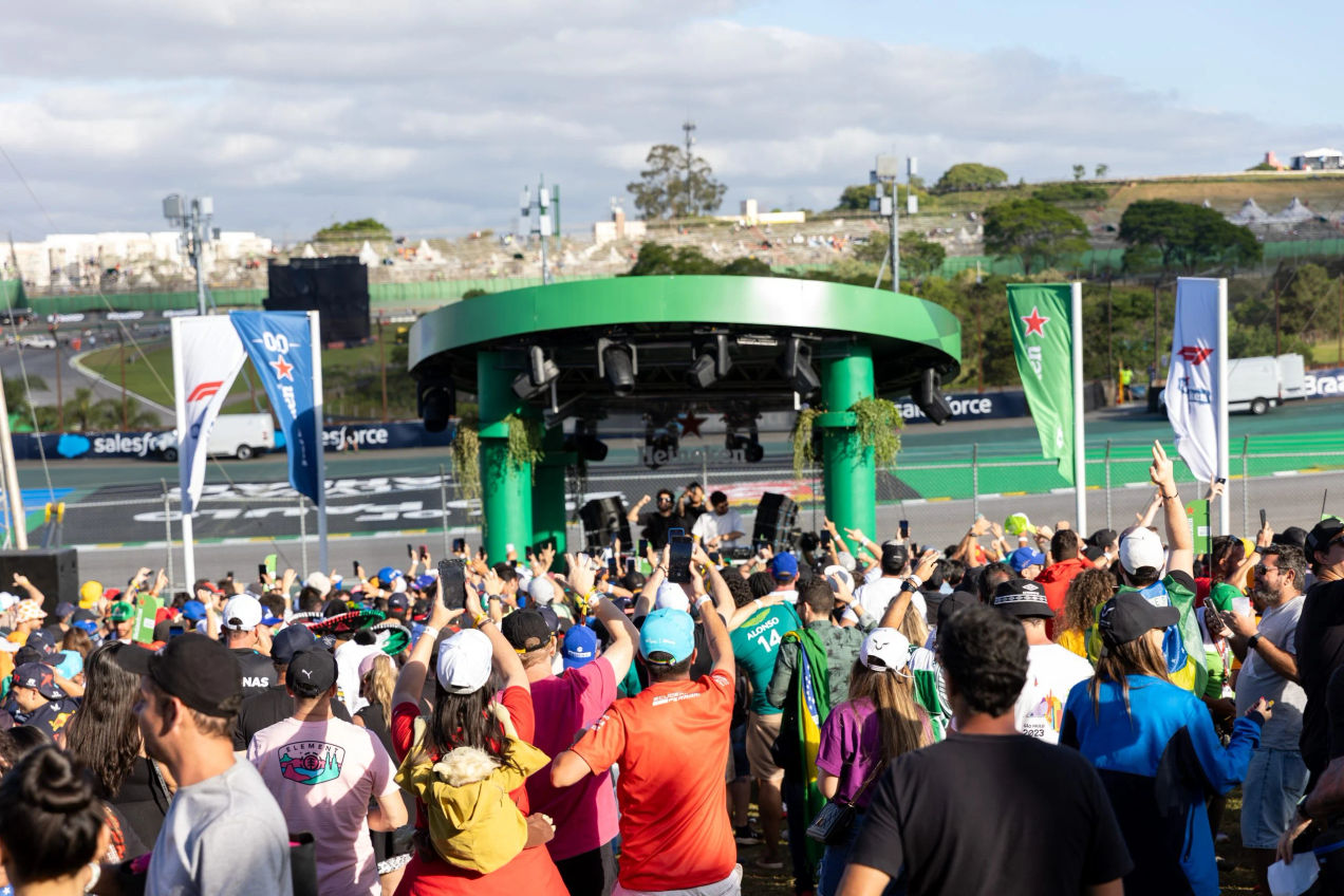 Crowds cheer for a DJ playing in the Heineken Village